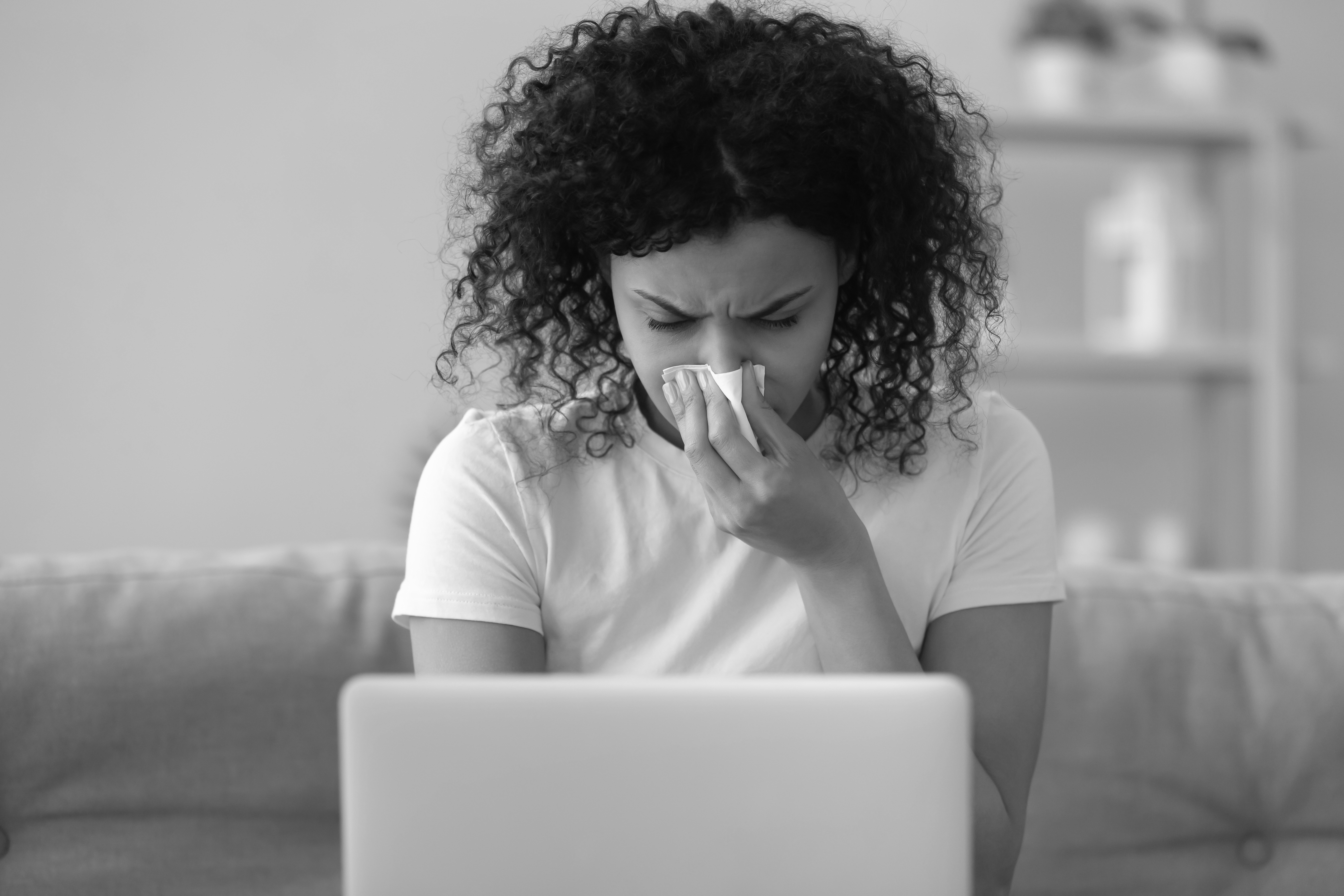 woman blowing her nose BW