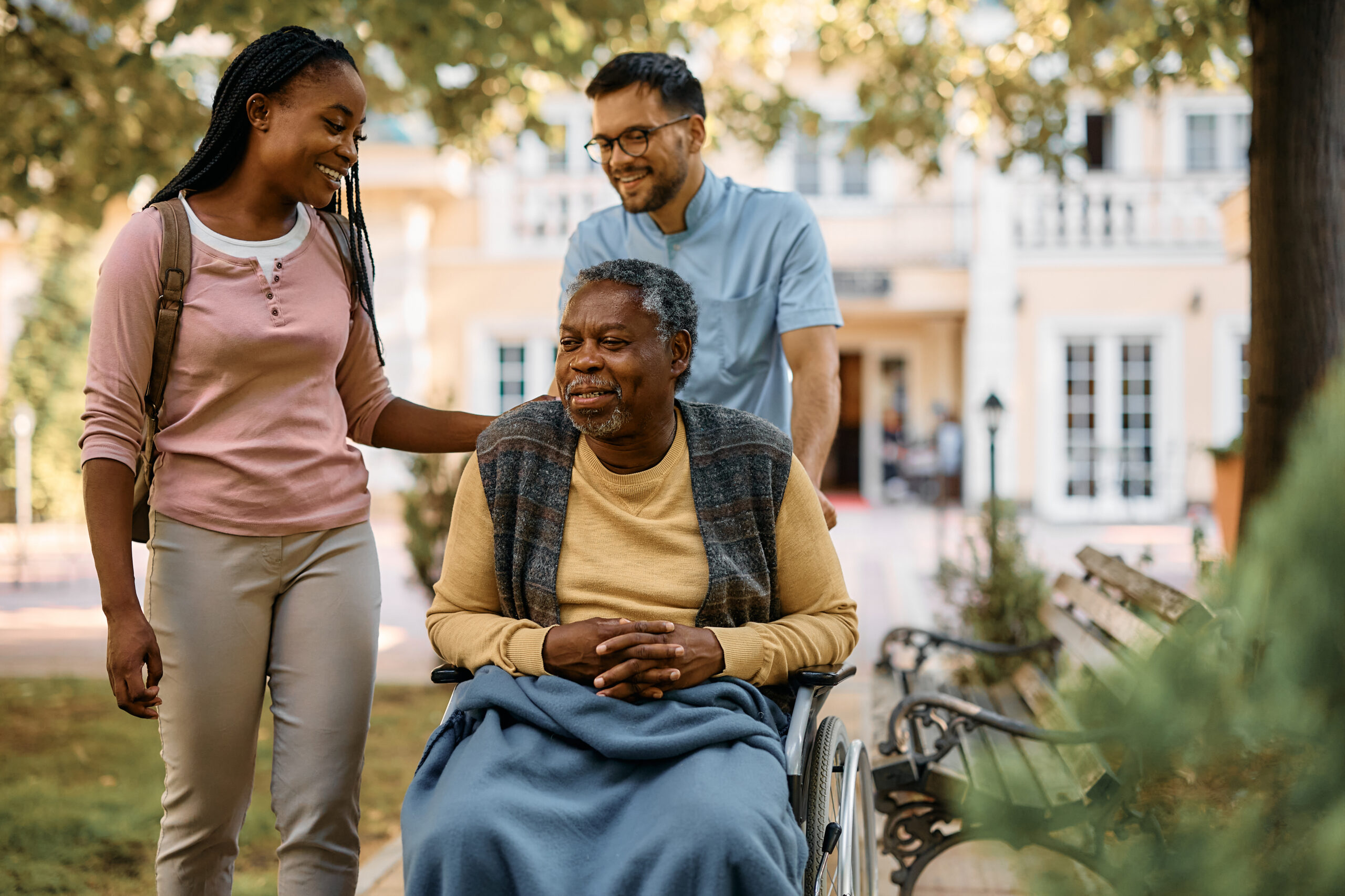 Happy woman visiting her senior father in nursing home.